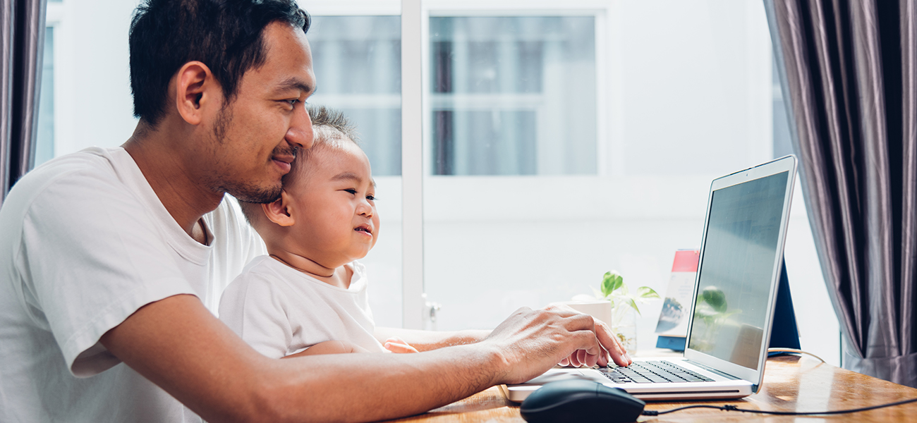 Composing email with baby on lap