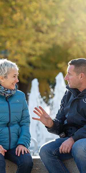 Two staff members in conversation at Martha Piper Plaza