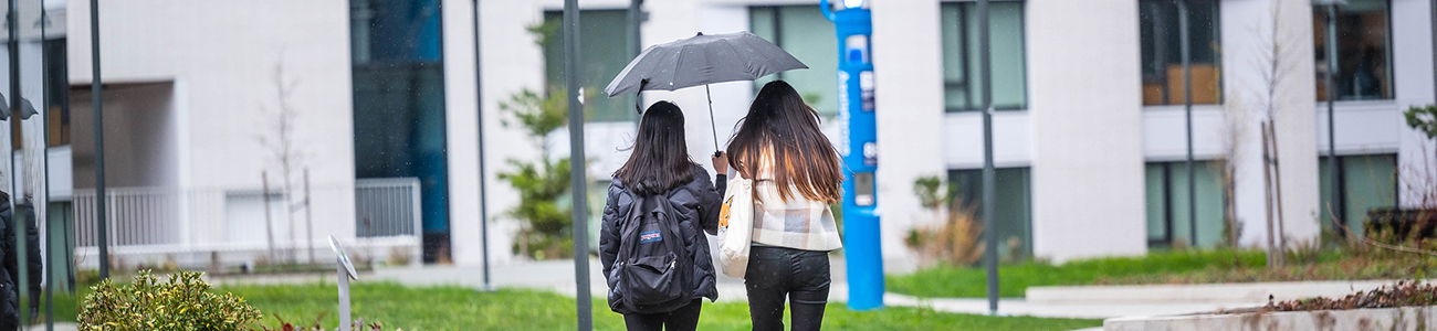 Students in the rain outside tə šxʷhəleləm̓s tə k̓ʷaƛ̓kʷəʔaʔɬ (The Houses of the Ones Belonging to the Saltwater)