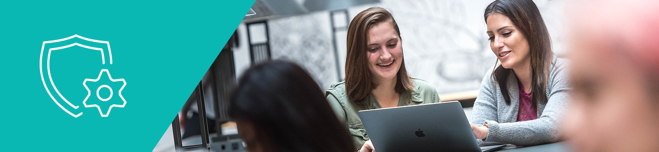 Student employees reviewing information on laptop