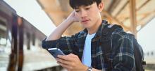 Worried man checks his social account on his phone